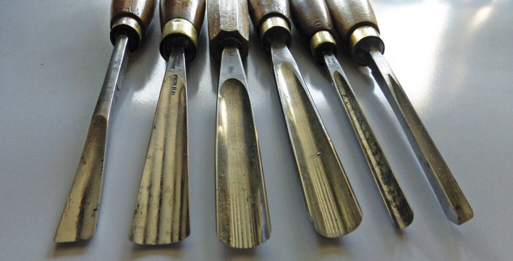Set of carving chisels with wooden handles.