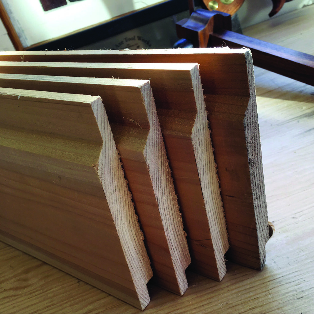 Stacked wooden boards with grooved edges on table.