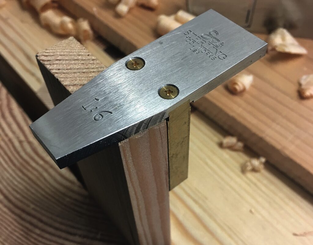 Precision dovetail tool on wooden surface.