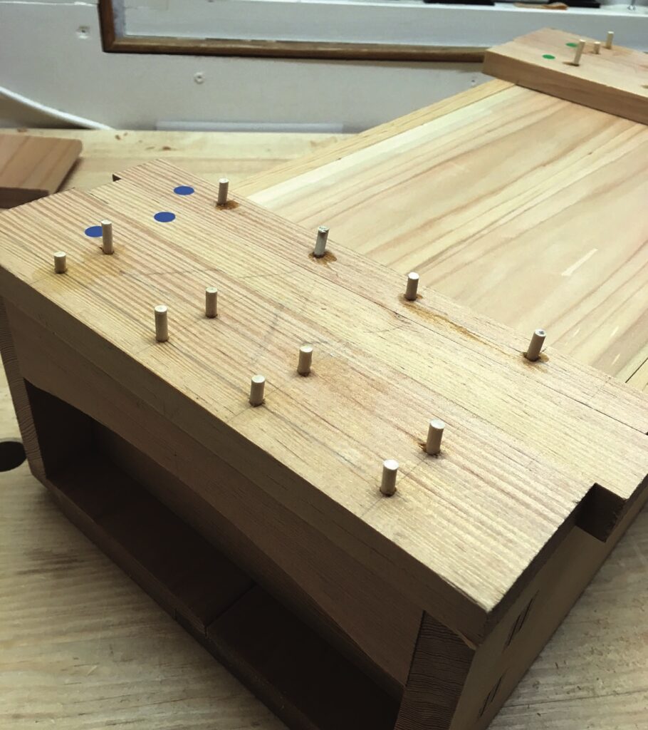Wooden structure with small pegs for assembly.