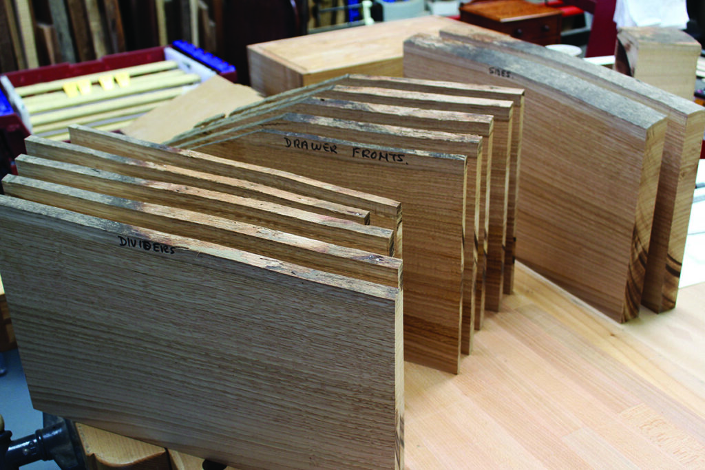 Stacked wooden panels labeled dividers and drawer fronts.