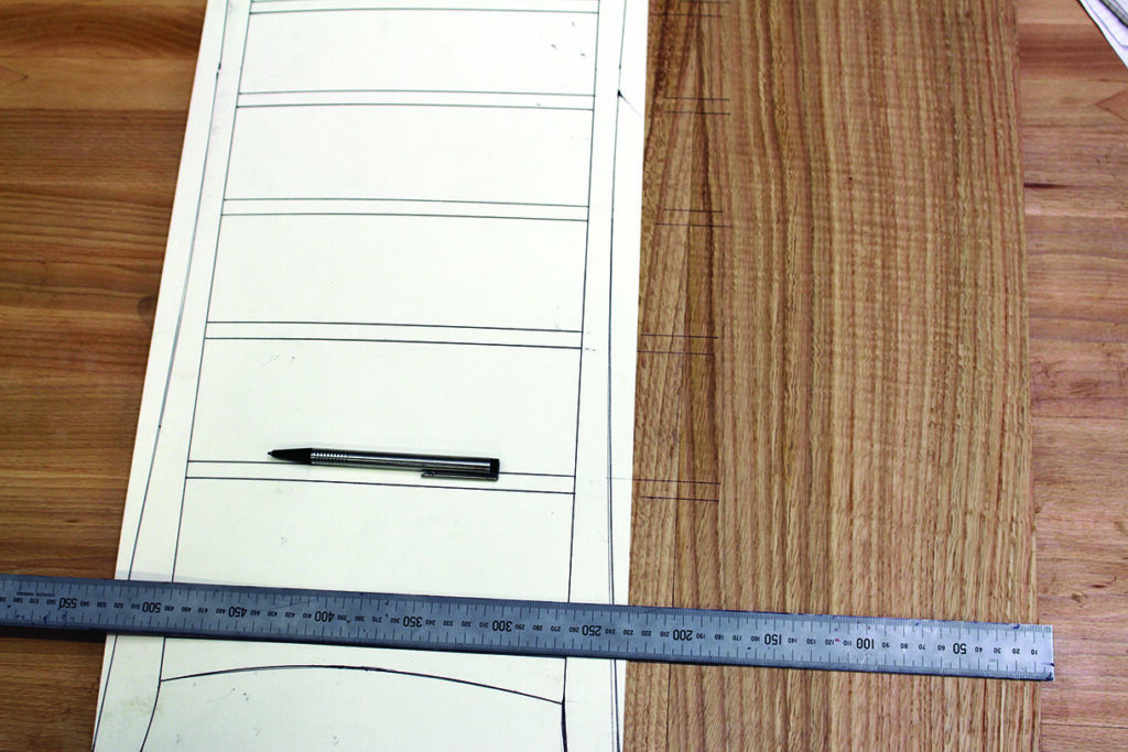 Woodworking plan with ruler and pen on table.