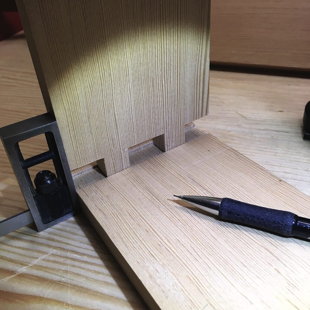Woodwork joinery with square and pencil tool close-up.