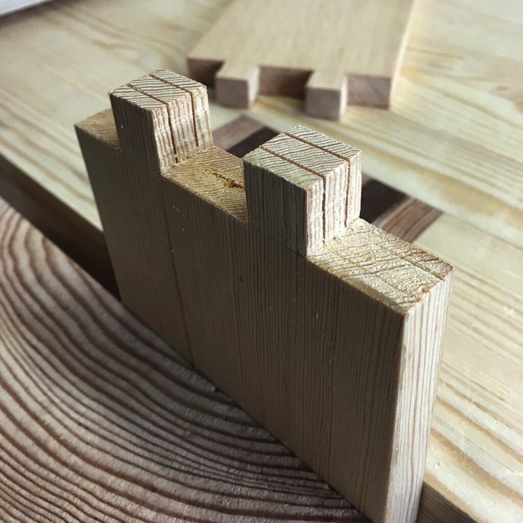 Detailed view of wooden dovetail joints in woodwork.