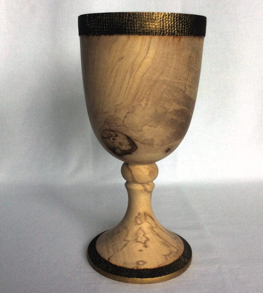 Handcrafted wooden goblet with dark rim design.