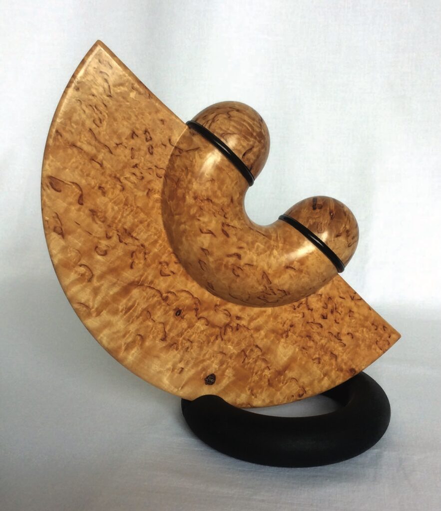 Decorative abstract wooden sculpture with curved design.