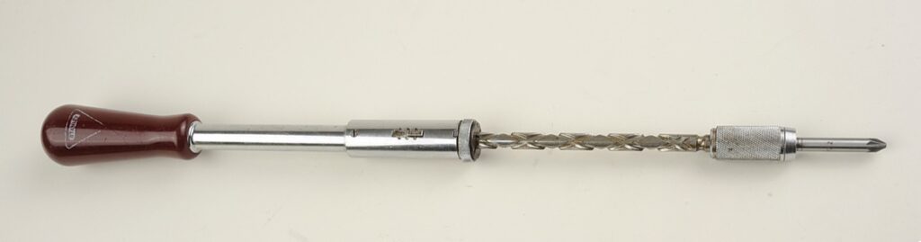 Vintage hand drill with wooden handle.