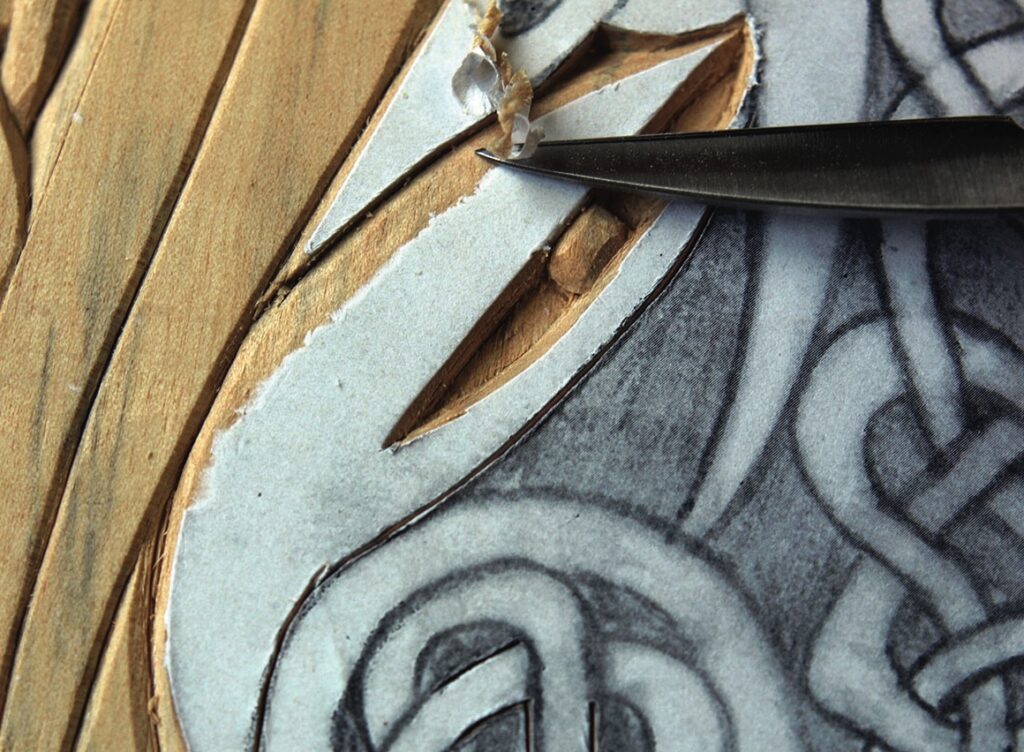 Chisel carving intricate wood design