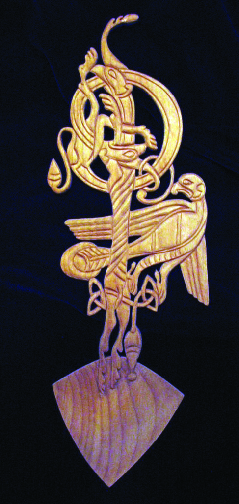 Intricate wooden Norse carving on dark background