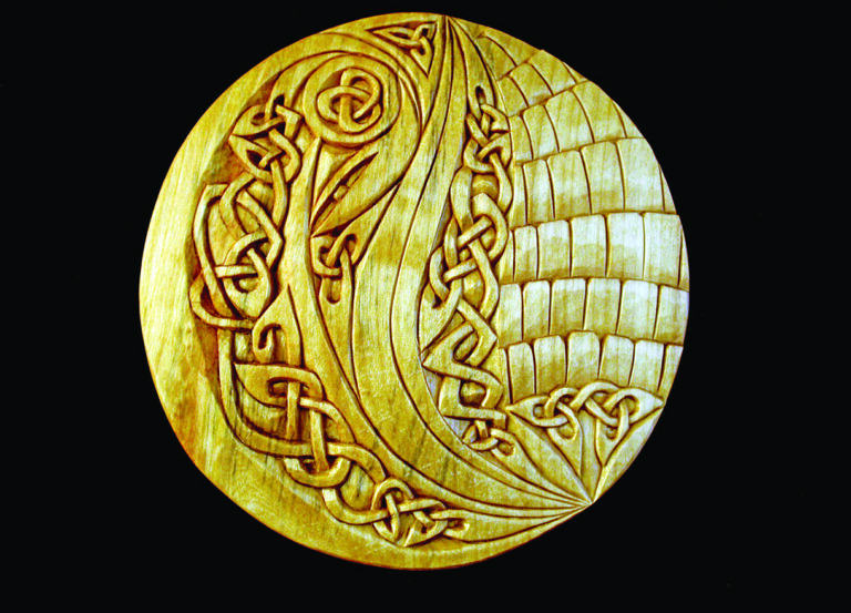Intricate Celtic knot design on circular panel.