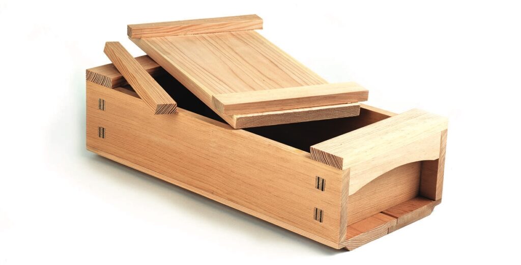 Open wooden puzzle box with sliding lid