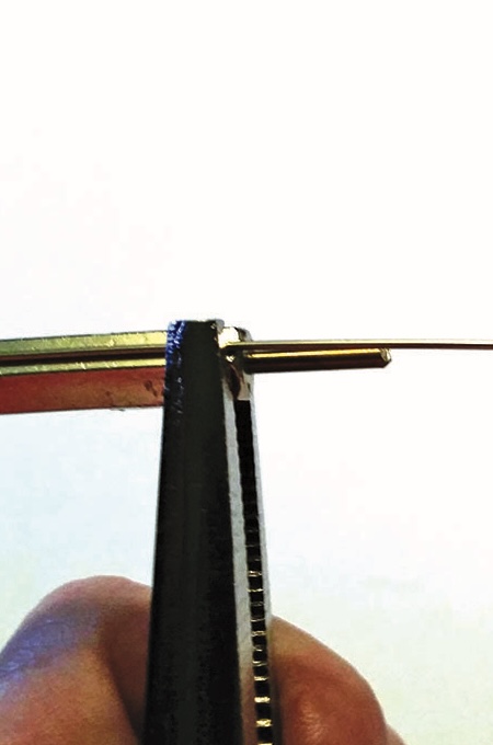 Pliers gripping wire for jewellery making.