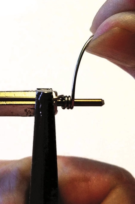 Close-up of wire being coiled with pliers