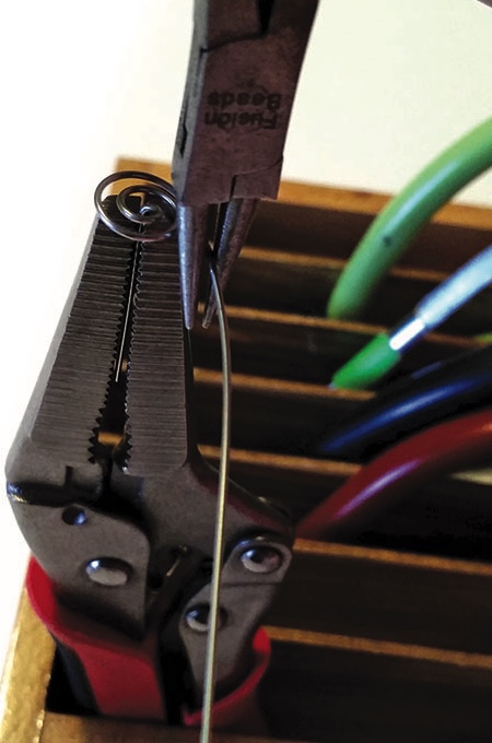 Pliers with wire in tool holder.