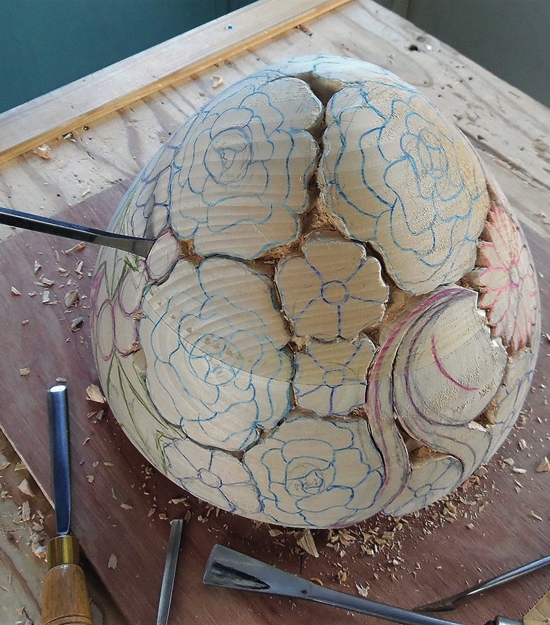 Wood carving with floral patterns in progress