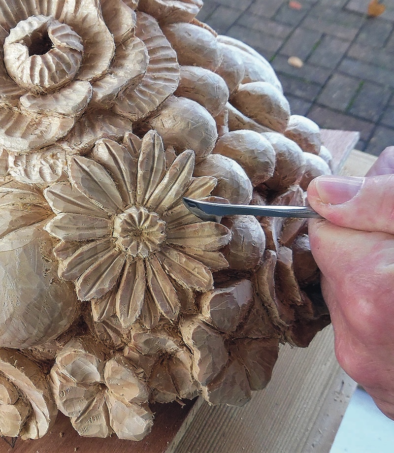 Hand carving floral wood sculpture detail.