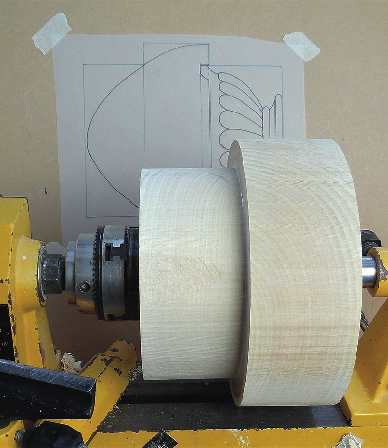 Woodturning lathe with unfinished wooden bowl