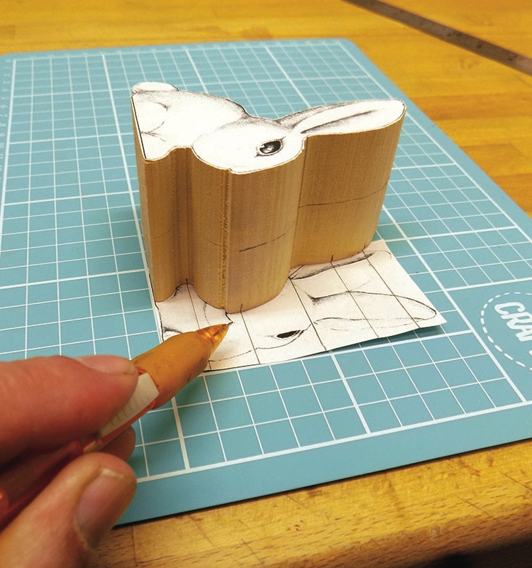 Drawing rabbit on folded paper sculpture