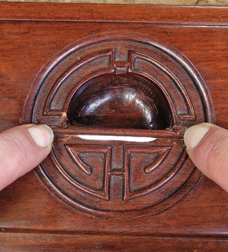 Hands opening vintage wooden compartment