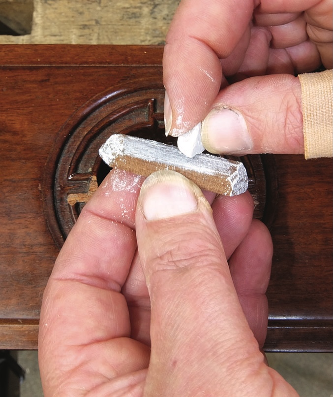 Applying wax to wooden furniture