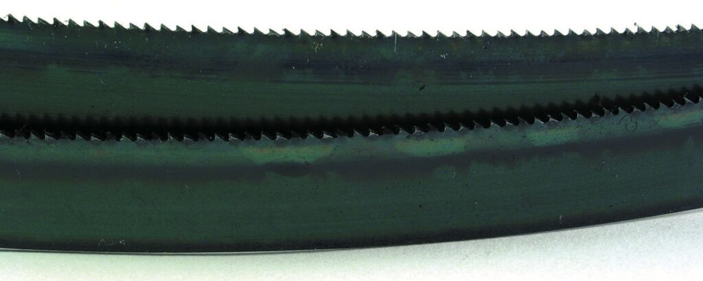 Close-up of a serrated saw blade.