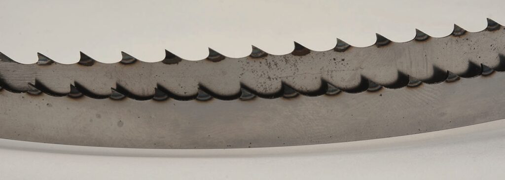 Close-up of saw blade teeth, detailed and sharp