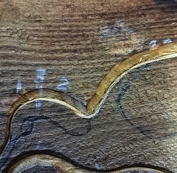 Close-up of carved wooden texture and grain patterns.