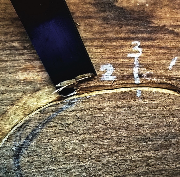 Wooden surface with chisel and marked numbers