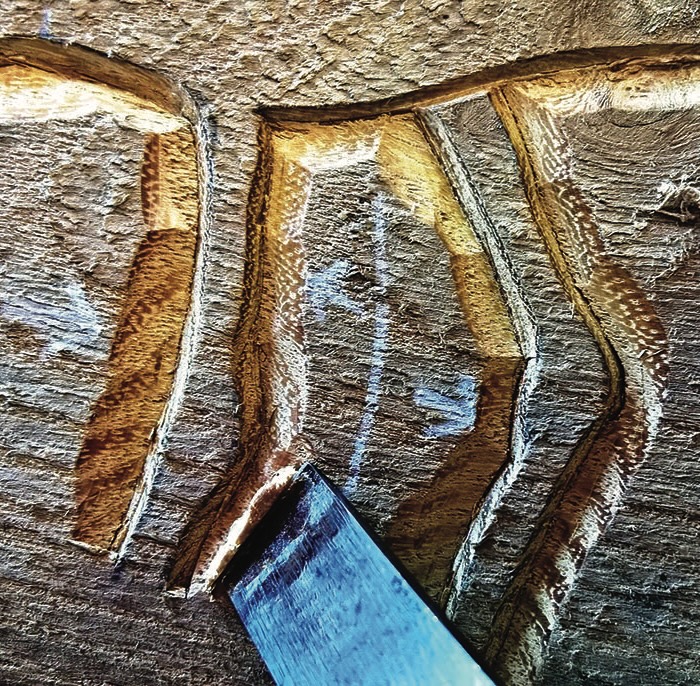 Wood carving detail with chisel tool.