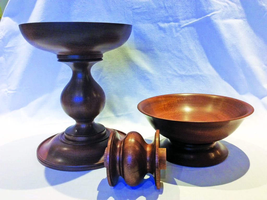 Wooden bowls and stand on white background.