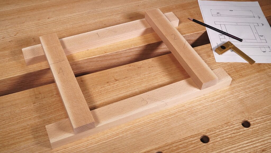 Woodworking project layout with tools and plans.