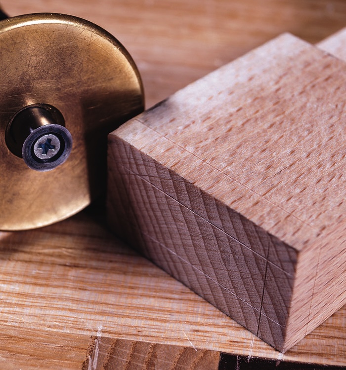Woodworking tool and wooden board close-up.