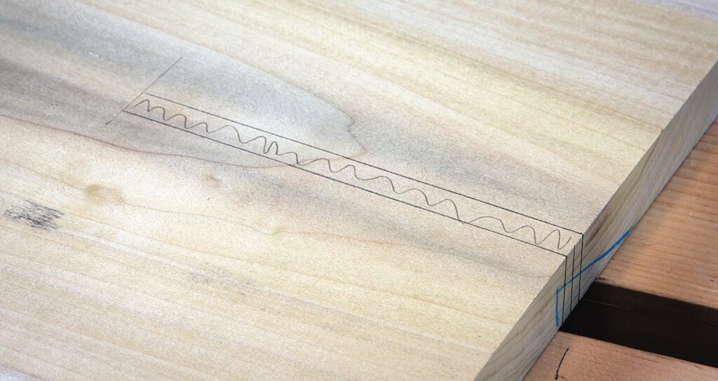Marked wood piece with wavy line design.
