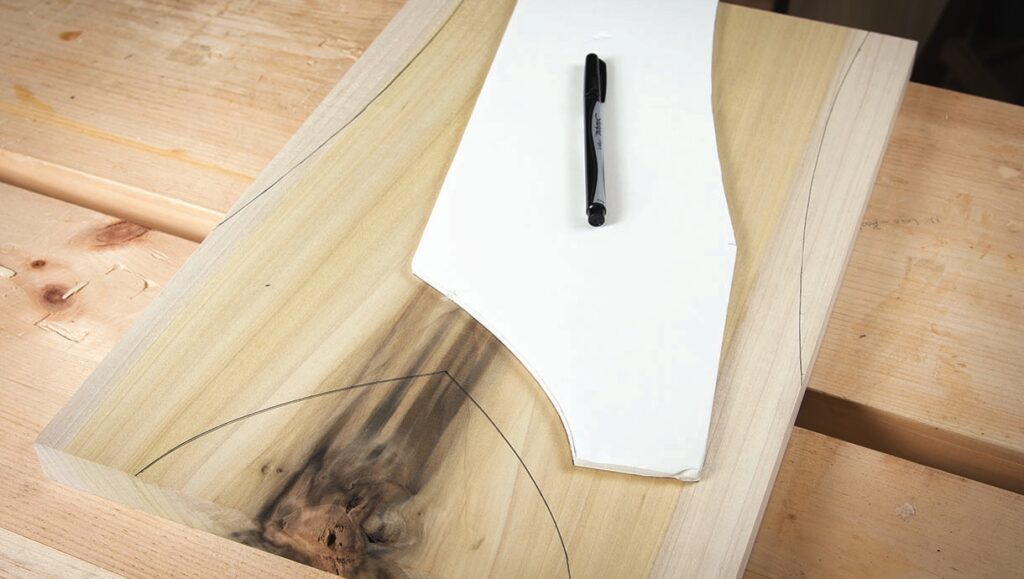 Wood template with paper and pen on table.