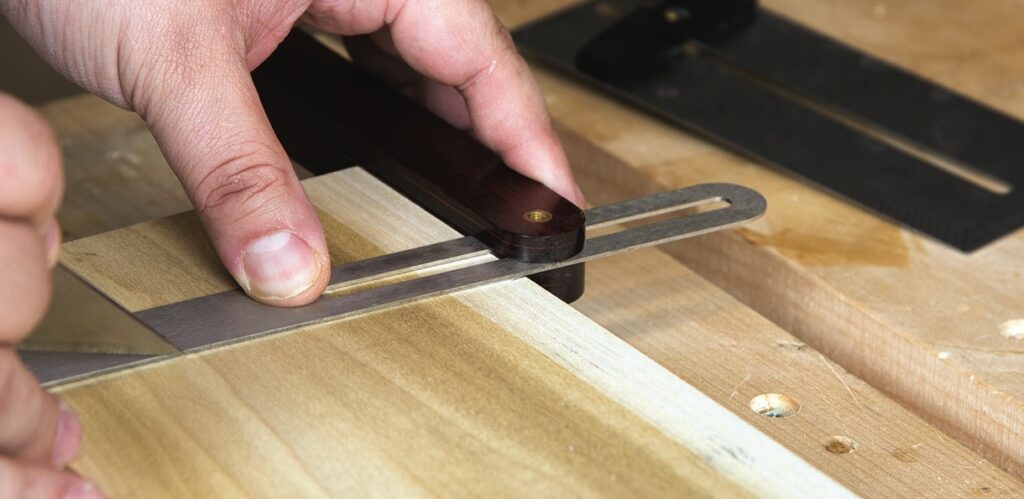 Adjustable woodwork marking gauge in use.