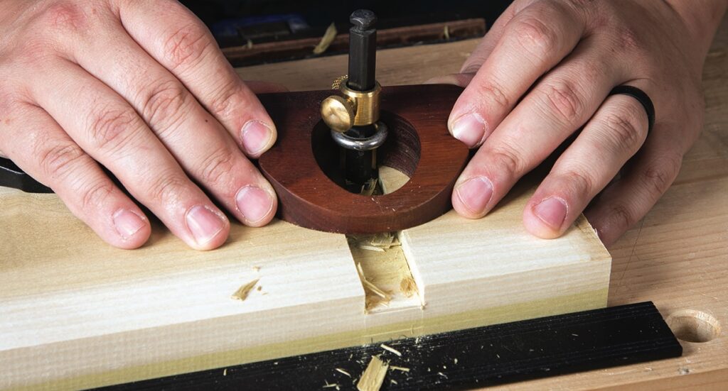 Person using a router plane on wood