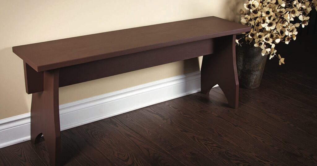 Wooden bench with decorative flowers nearby.