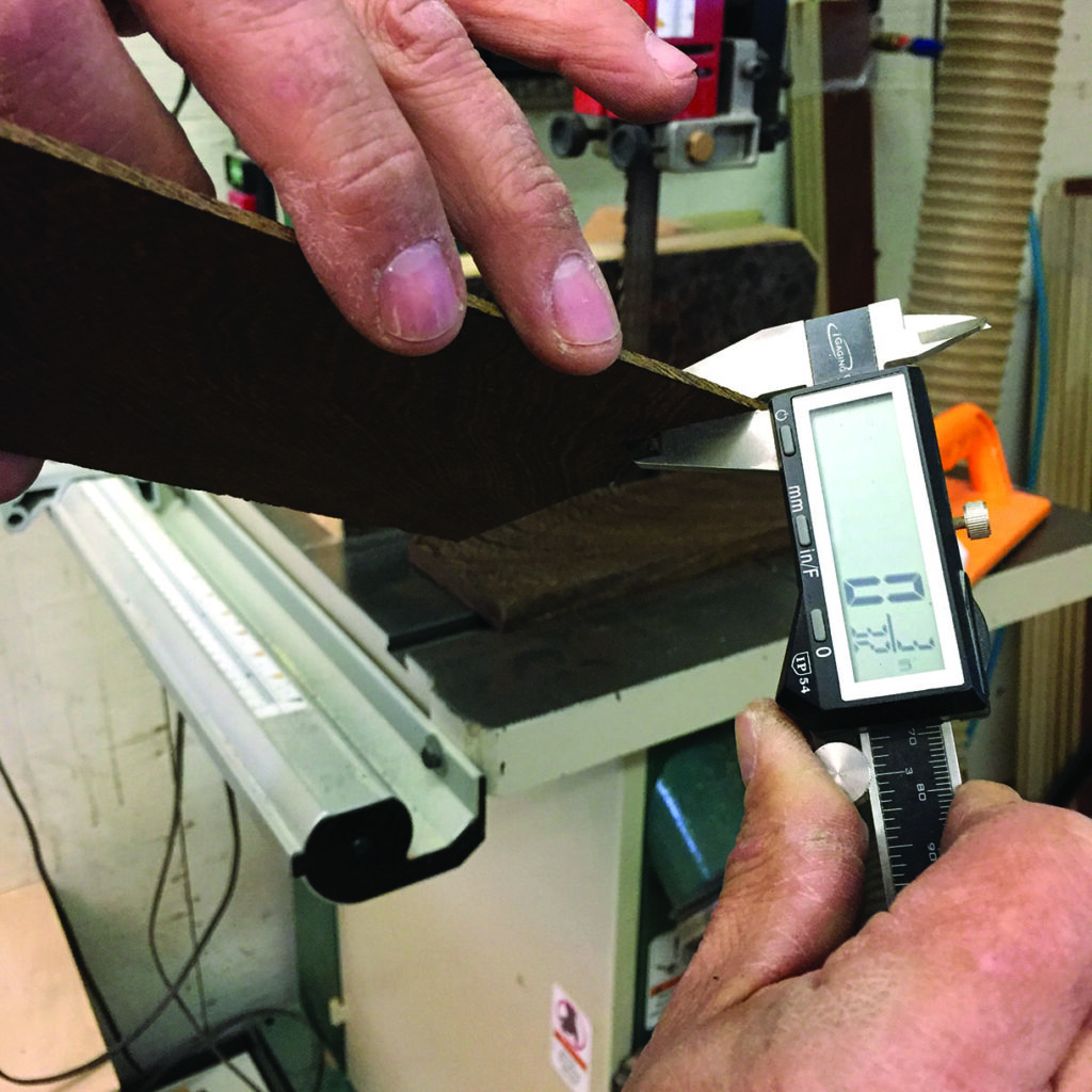 Measuring wood thickness with digital caliper.