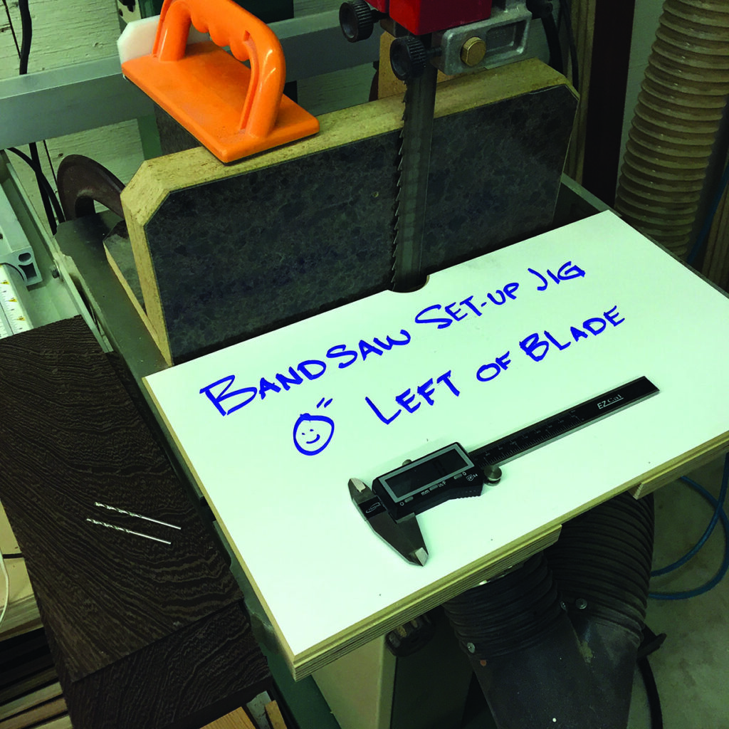 Bandsaw setup with caliper and sign.