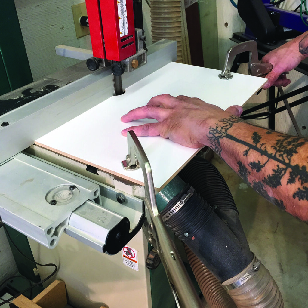Man using table saw to cut wood
