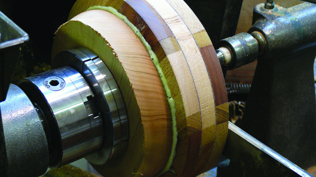 Wood lathe shaping layered wooden block