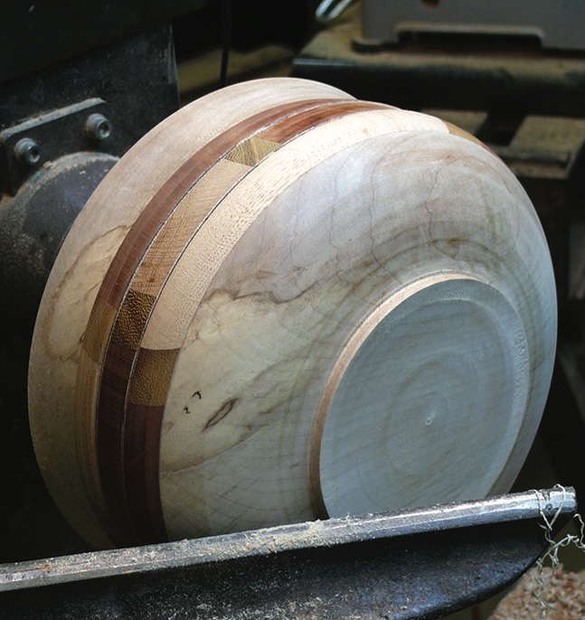 Wooden bowl on lathe being turned