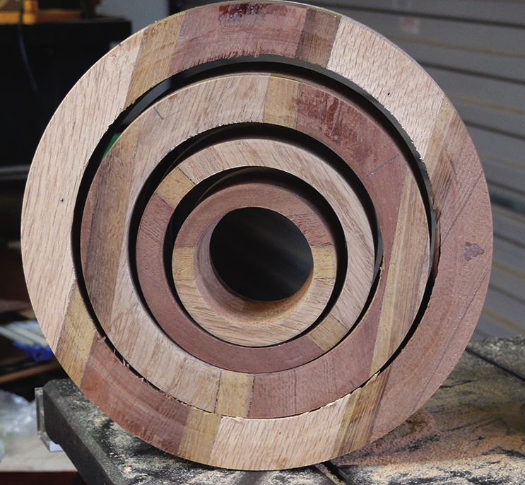 Concentric wooden rings in workshop setting.