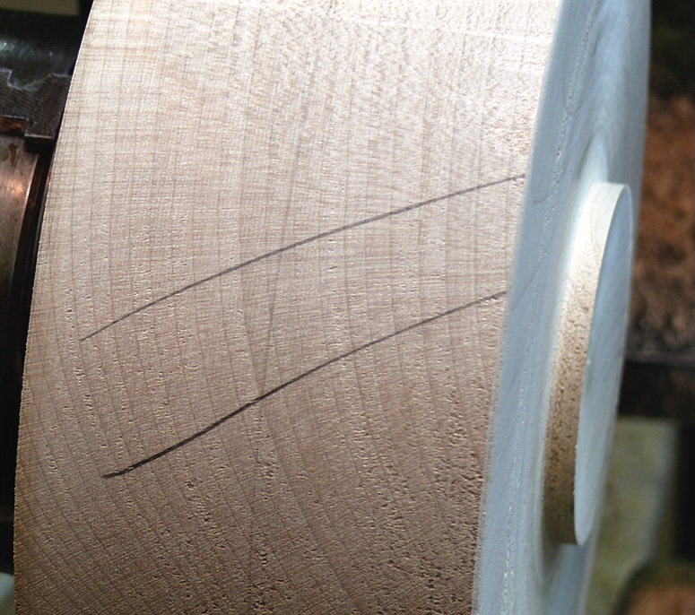 Close-up of woodturning process on lathe.