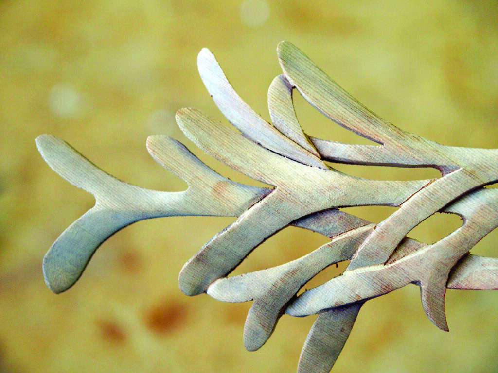 Abstract wooden sculpture with interwoven branches.
