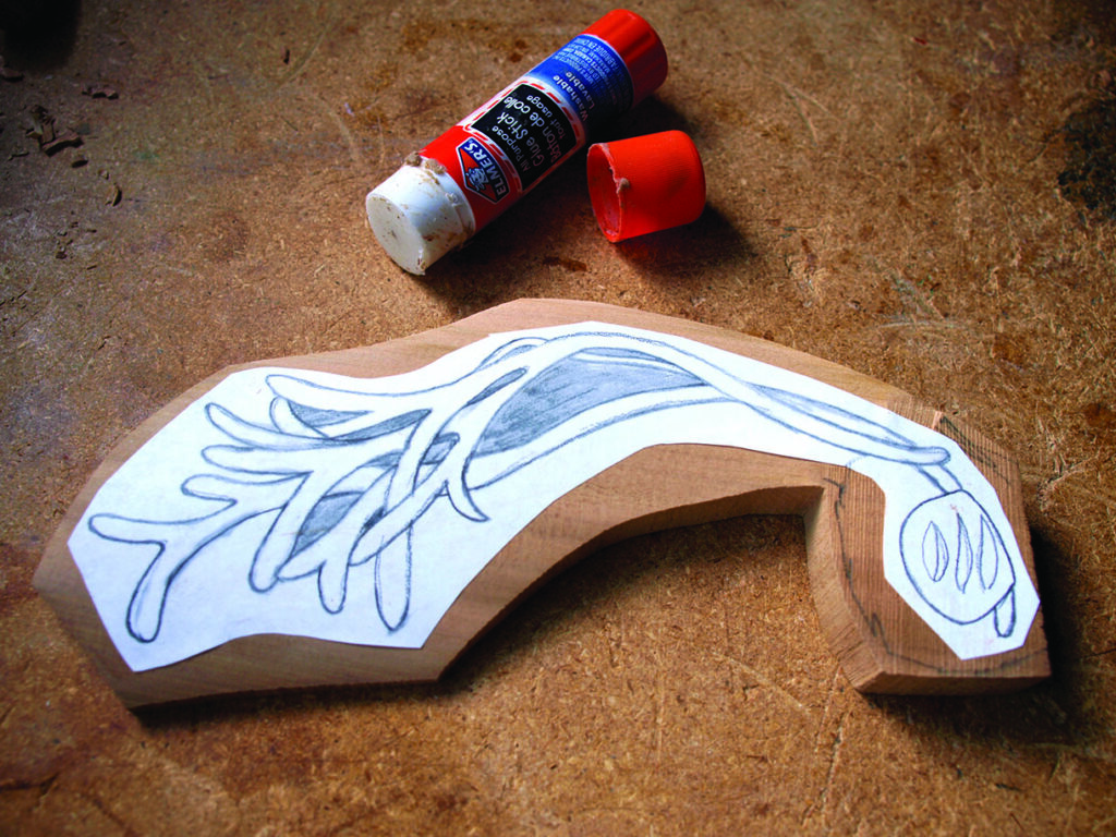 Wood carving design with glue stick on table.