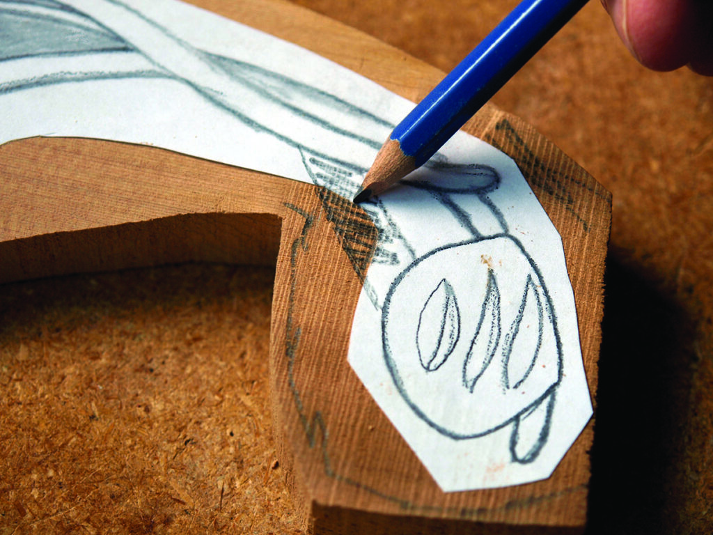 Hand drawing on wooden piece for carving