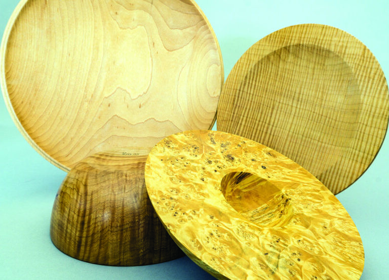 Three decorative wooden bowls displayed together.