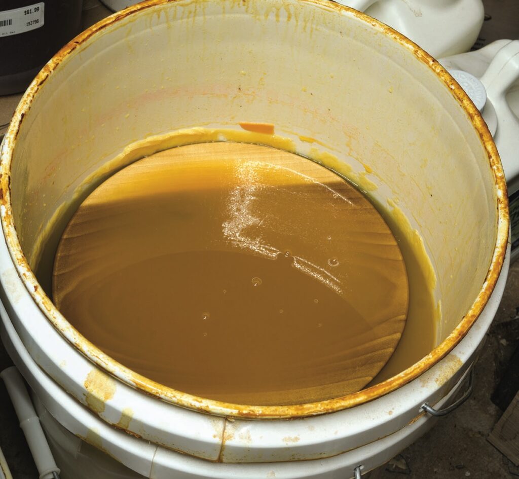 Large barrel of honey with visible wax layer.