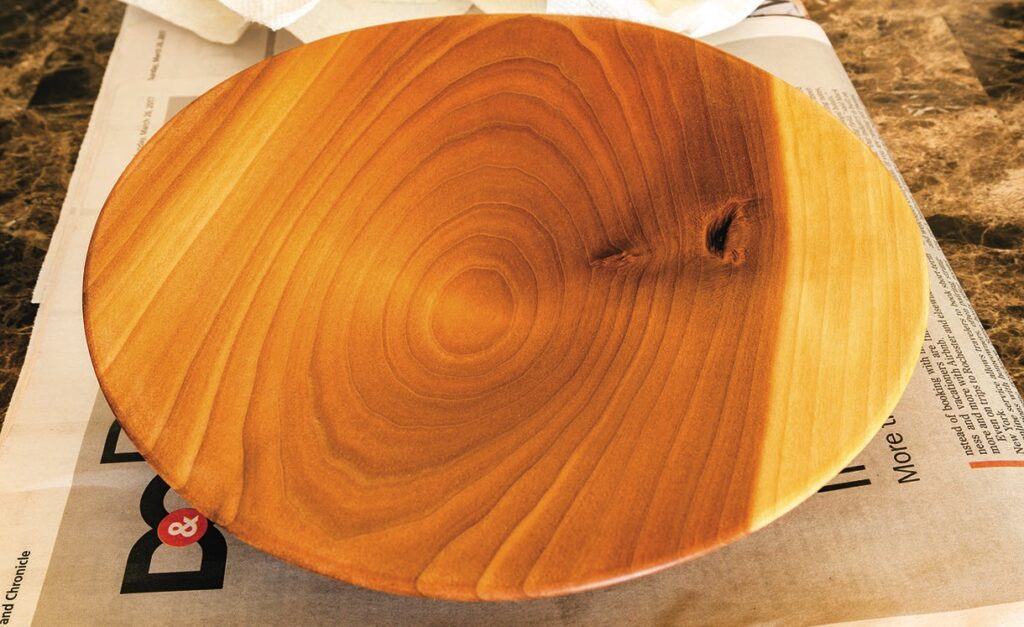 Round wooden platter on newspaper